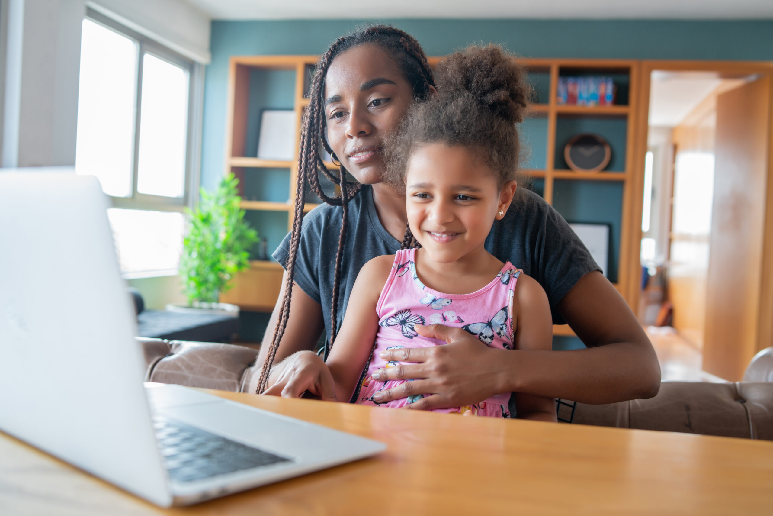 Mother and daughter on a video call with doctor.